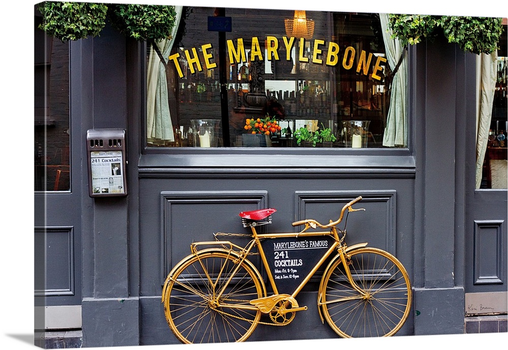 Photograph of a gold bike leaning up against The Marylebone, advertising their cocktails, London, England.