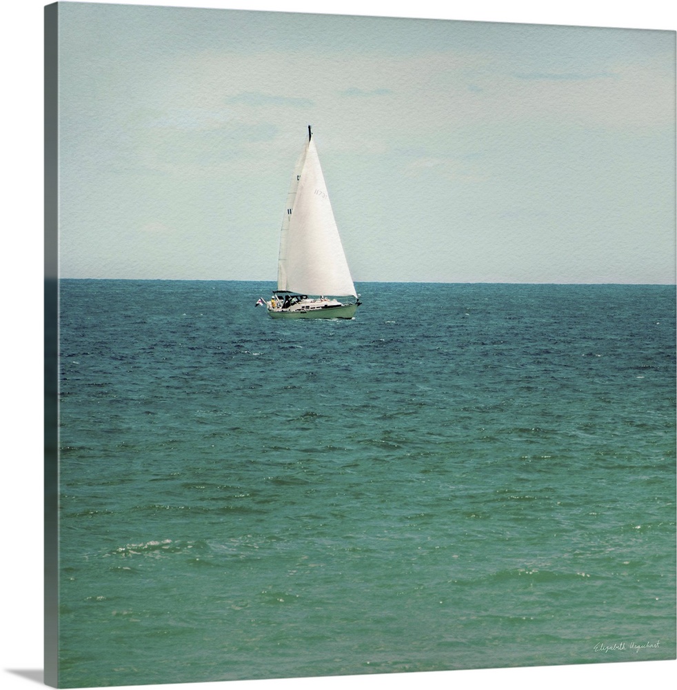 A photograph of a sailboat out on a green sea.