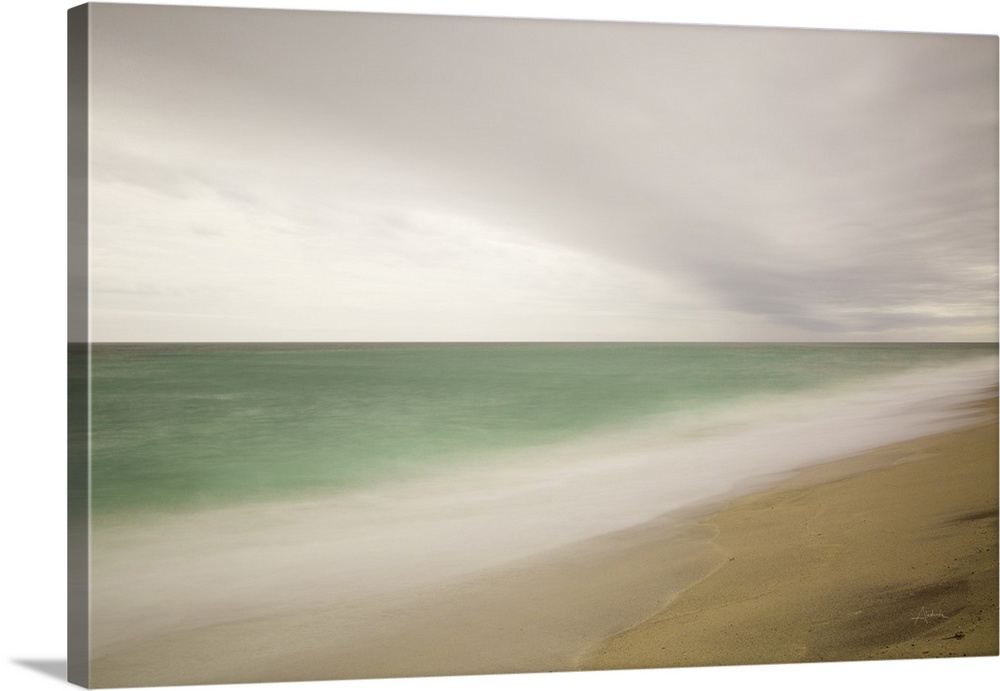 Photograph of a beach with smoothed waves and clouds.