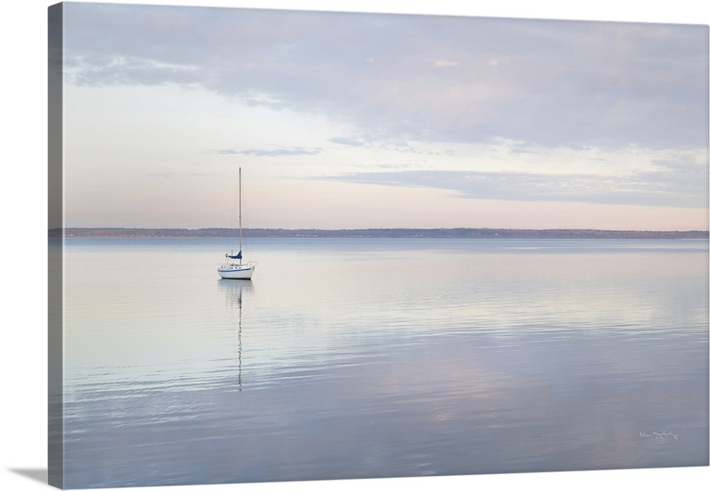 Sailboat and morning clouds reflected in calm waters of Bellingham Bay Washington.