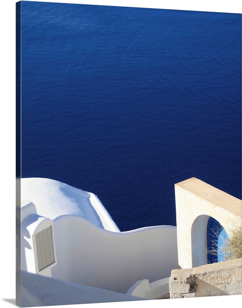 Landscape photograph of the bright blue water in Santorini.