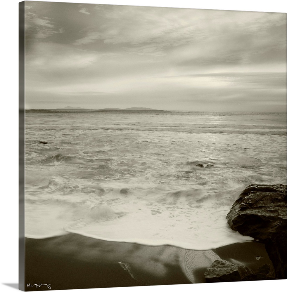 Black and white photograph of a seascape view from a the shoreline of a beach.