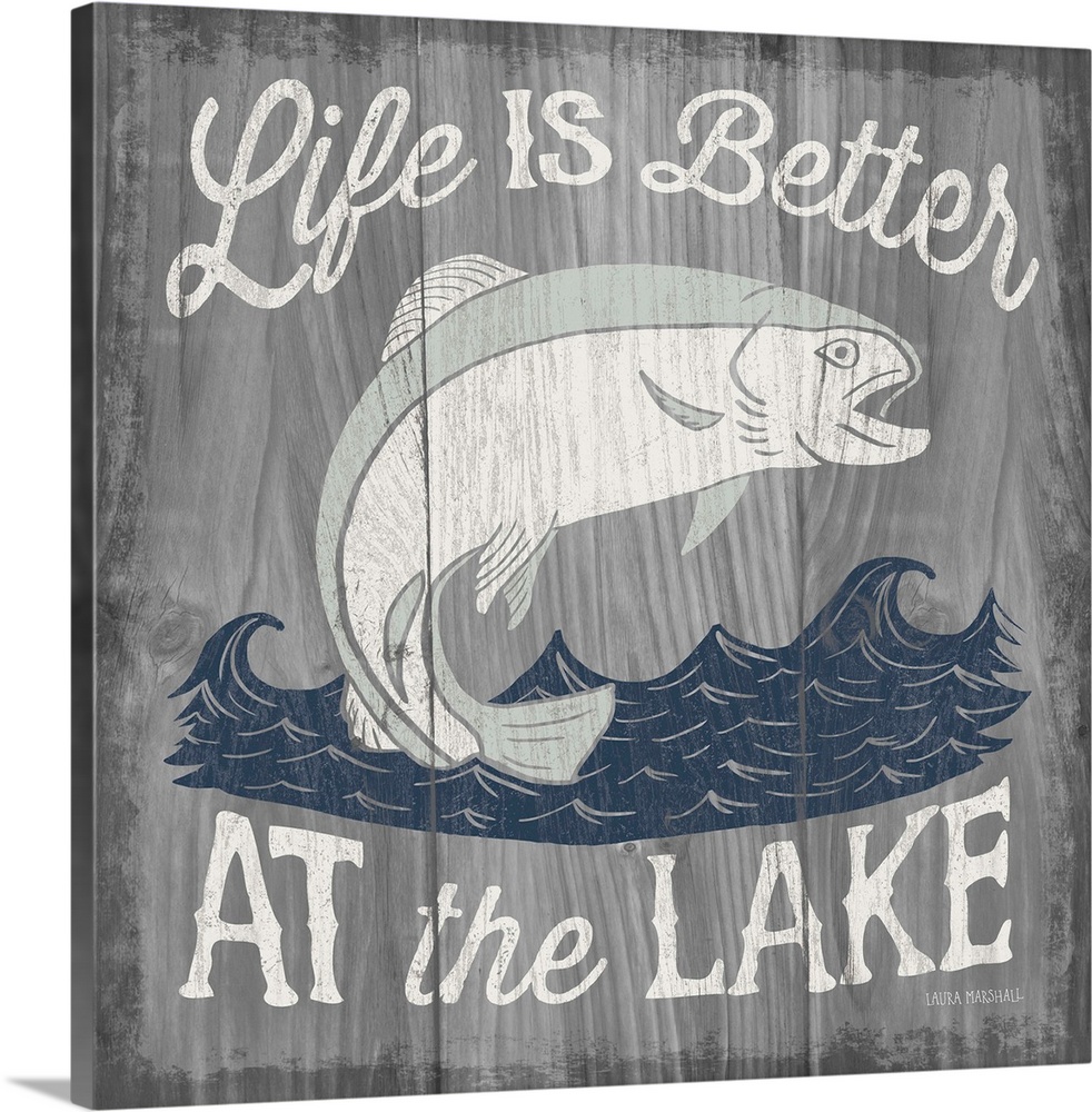 "Life is Better at the Lake" in white with an illustration of a fish jumping out of water on a  grey wood grain background.