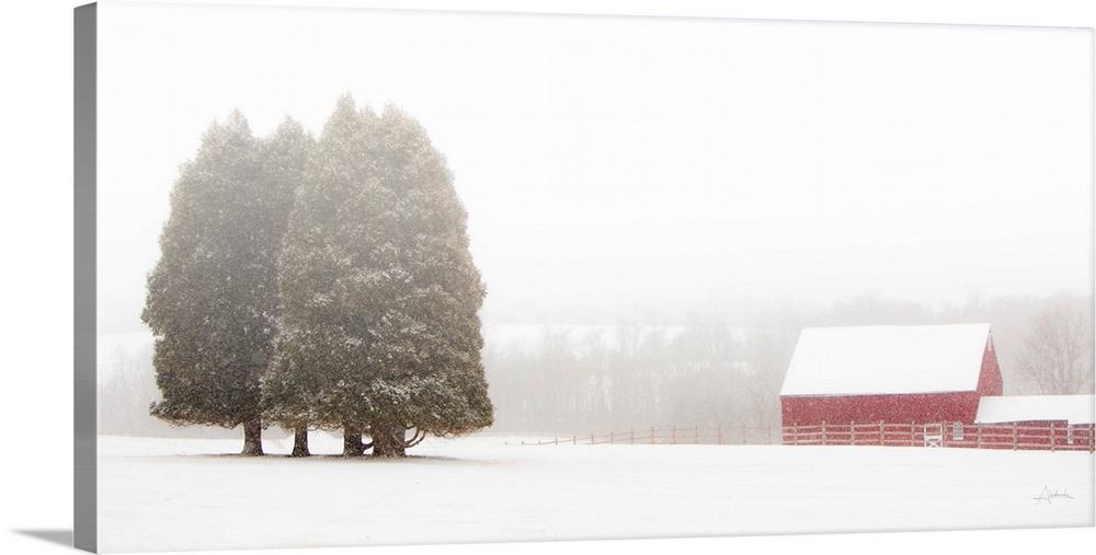 Image of snow falling on a snow covered red barn in a field.