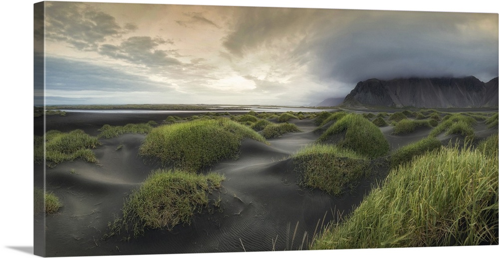 Stormy clouds gather over tranquil dunes in this beach landscape photograph.