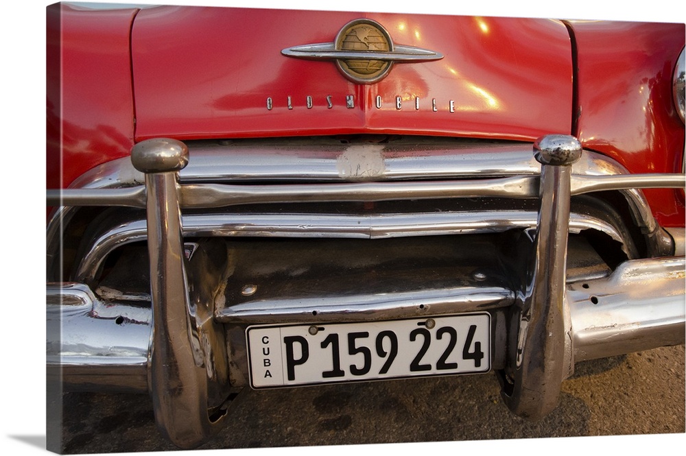 A photograph of a colorful vintage car in Cuba.