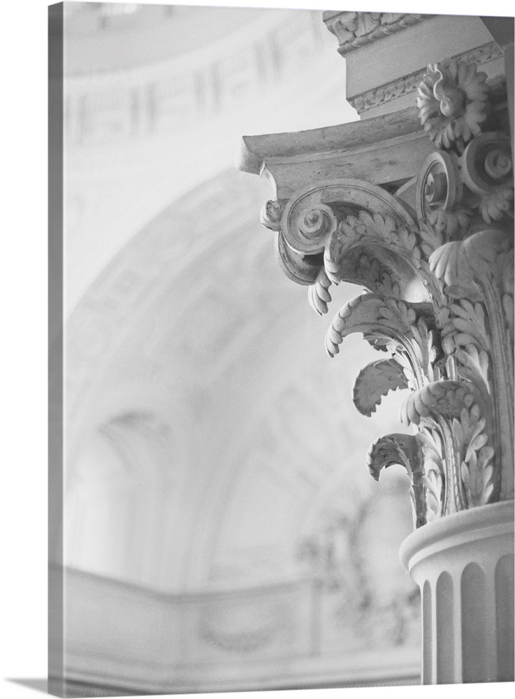 A black and white photograph of the detail of an architectural column featuring scrolls, daisies and agapanthus leaves.