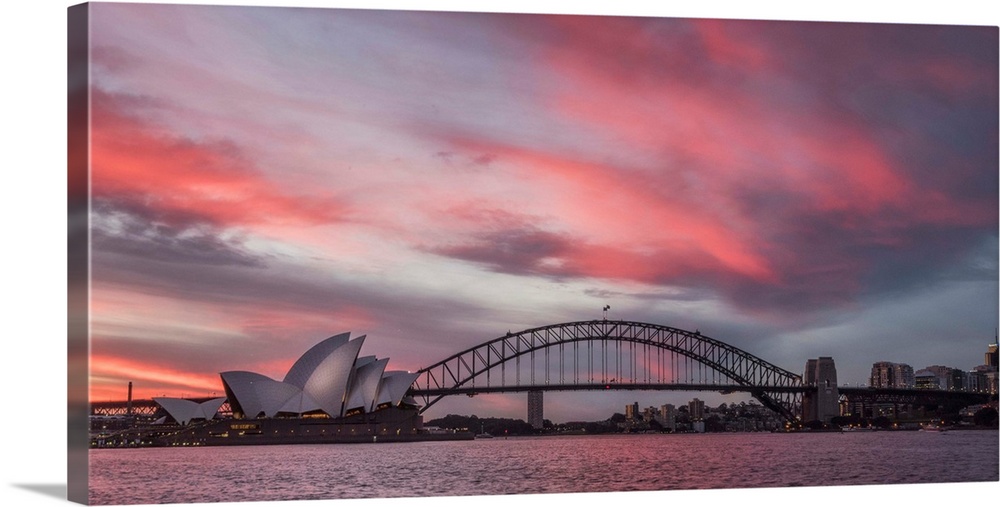 Panoramic photograph of the Harbor Bridge in Sydney, Australia at sunset.