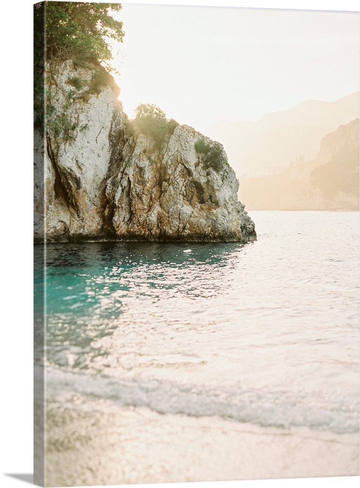 Photograph of gentle waves lapping the shore of Corfu Island, Greece.