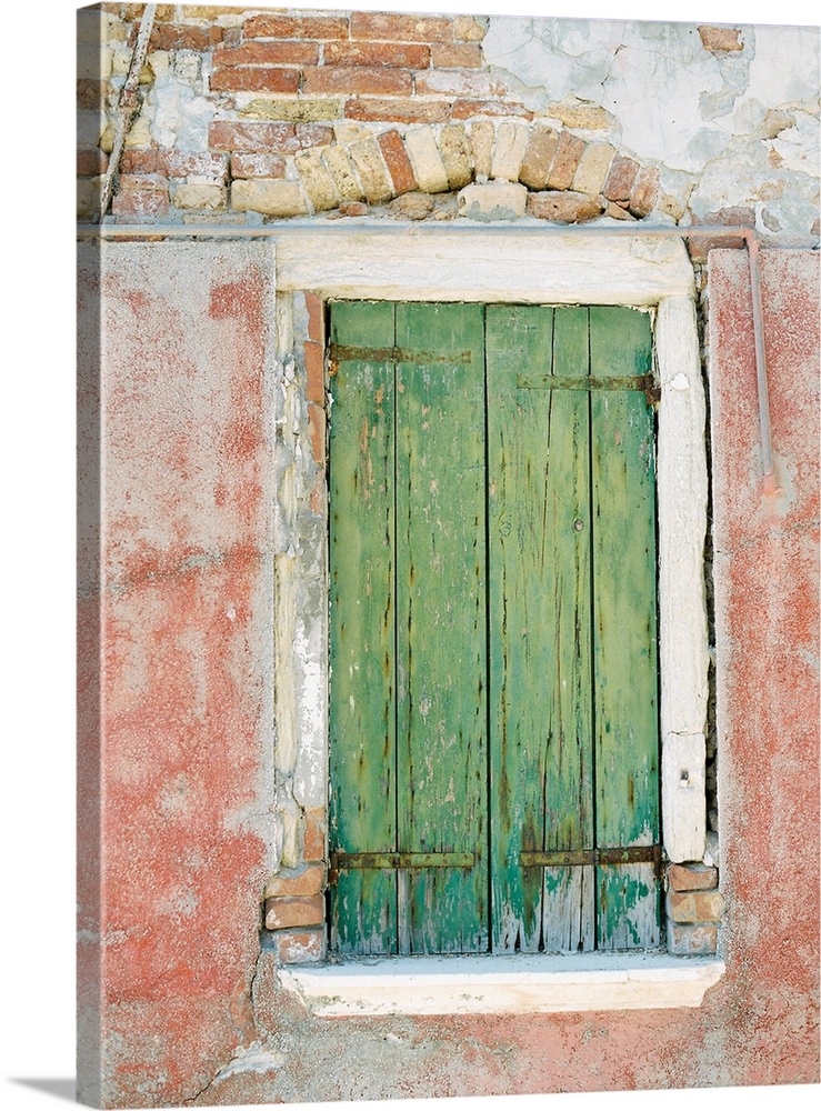 Photograph of a small window with ancient green shutters, Burano, Italy.