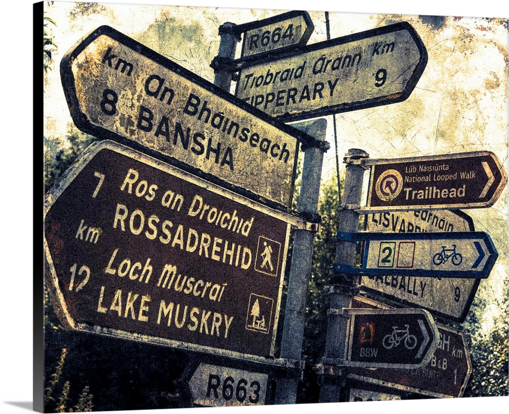 Fine art photo of a signpost in Ireland with several directional signs, with a grunge effect.
