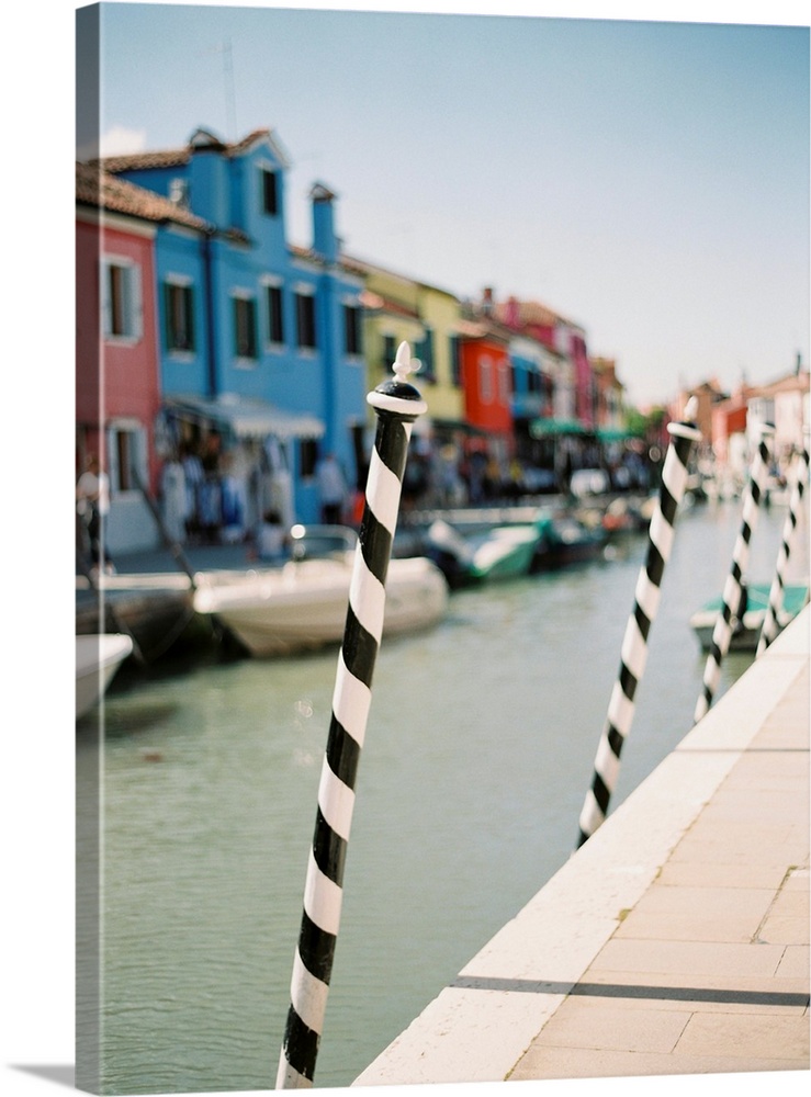 Photograph of the black and white poles used for mooring gondolas, Venice, Italy.