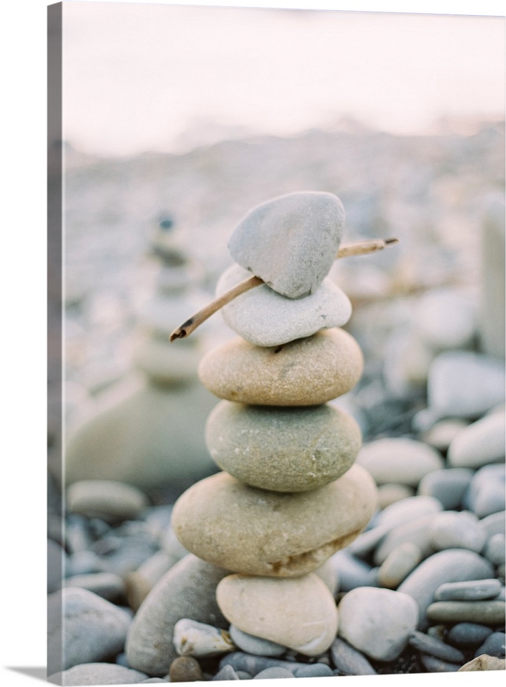 Photograph of stack of small pebbles on the beach, California.