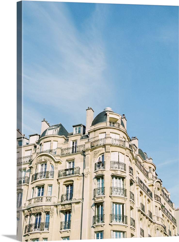 Photograph of Paris apartments buildings beneath a blue sky.