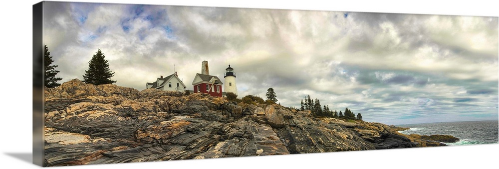 Panoramic photography of Pemaquid Lighthouse on the rocky coast under stunning clouds.