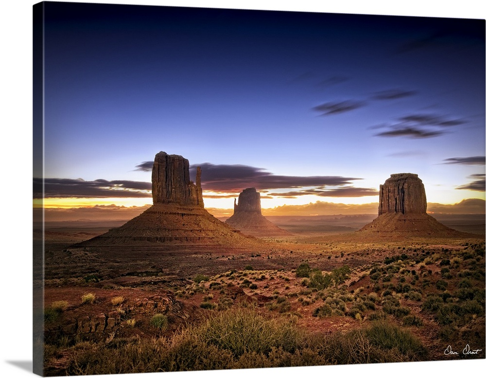 Beautiful photograph of the canyons in Monument Valley, AZ at sunset.