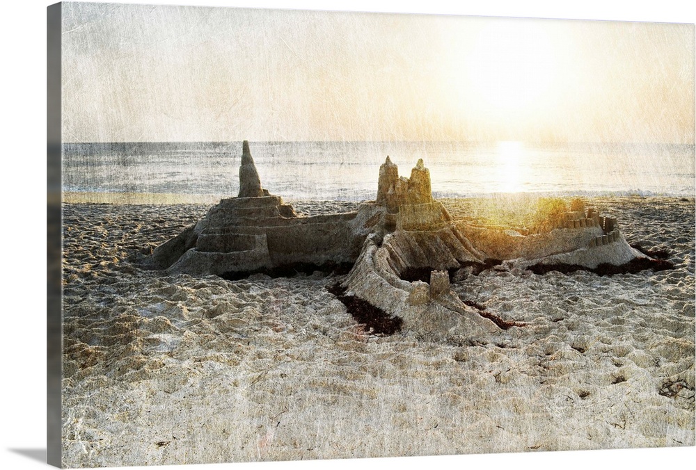 Photograph of a sand castle on a beach with a rough textured overlay.