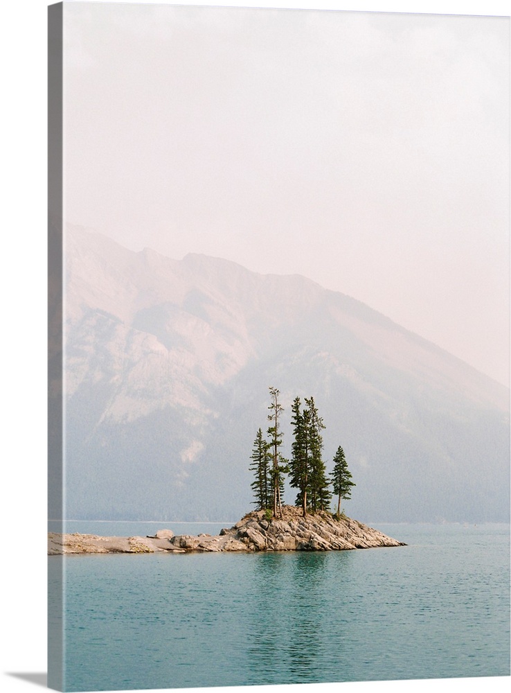 Photograph of several trees on a small island under a hazy sky, Banff, Canada.