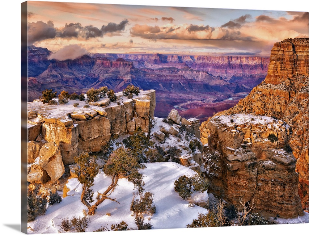 Vista of the Grand Canyon in Arizona on a cloudy day under a blanket of snow.