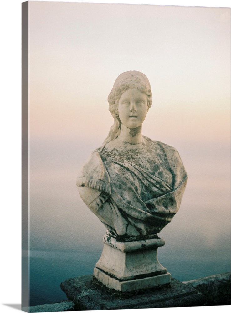 A photograph of a simple, classic bust statue on a stone railing, Lake Como, Italy.