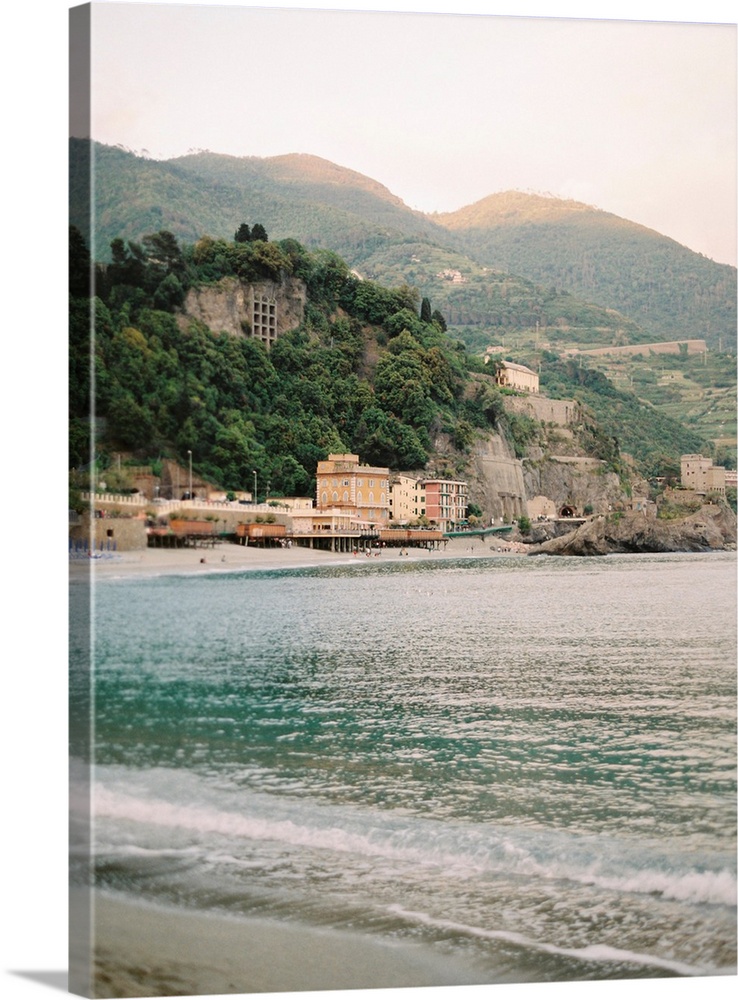 Photograph of the water in front of a sunlit town, Cinque Terre, Italy.