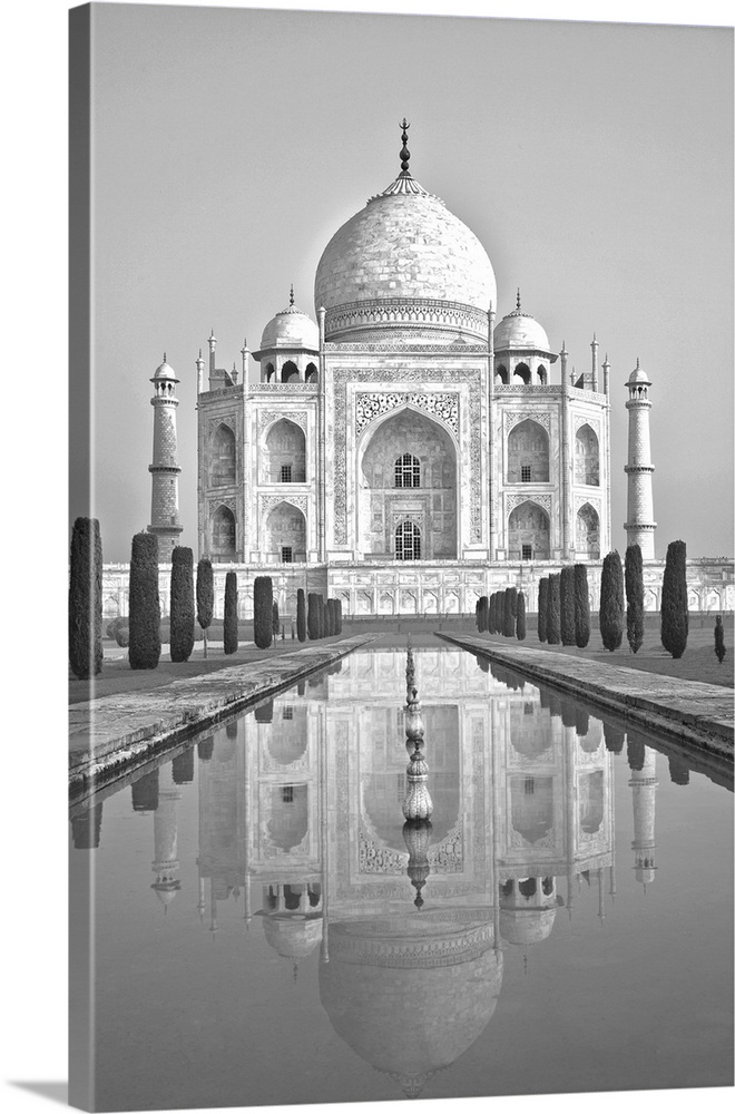 Black and white image of the Taj Mahal reflected in the pool below in Agra, India.