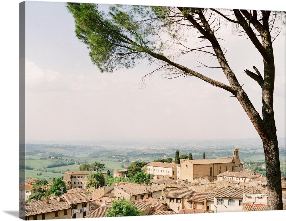Photograph of village in Tuscany with rolling landscape in the distance.