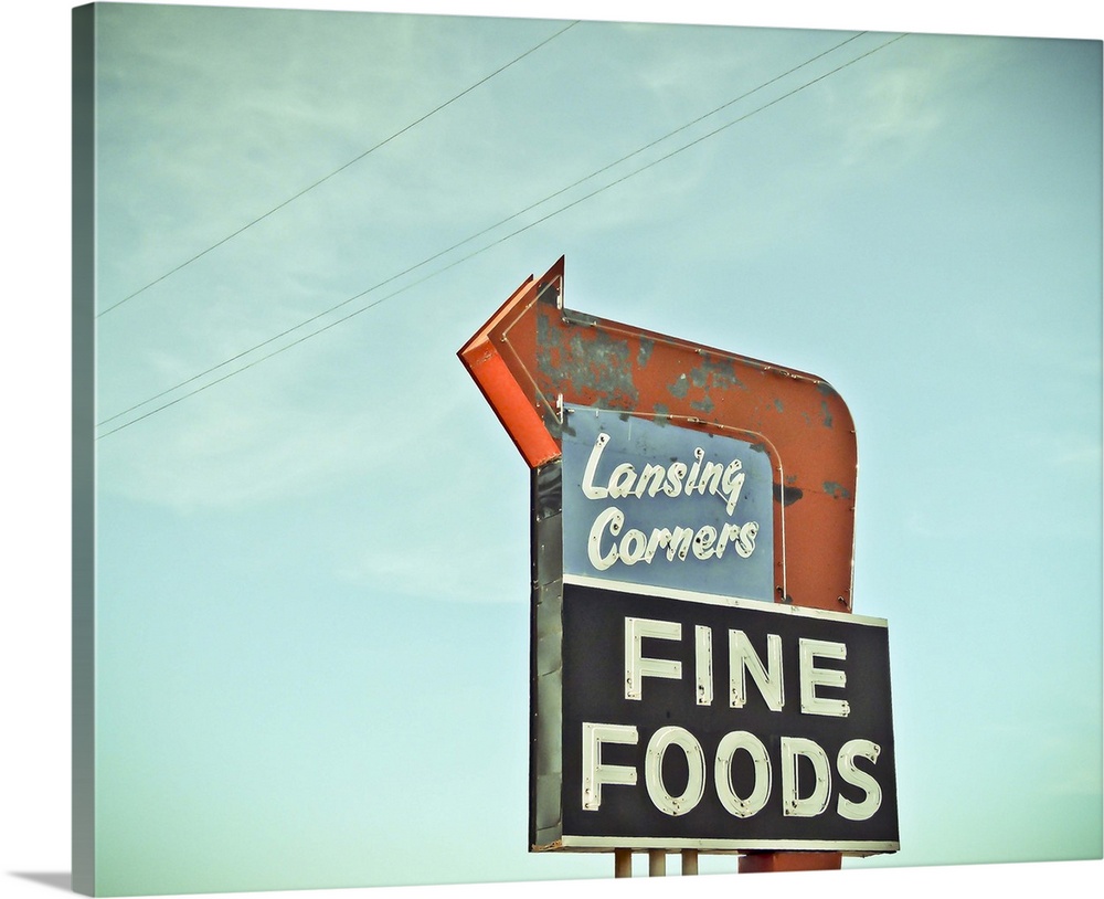 Photograph of a retro restaurant sign against a blue sky.