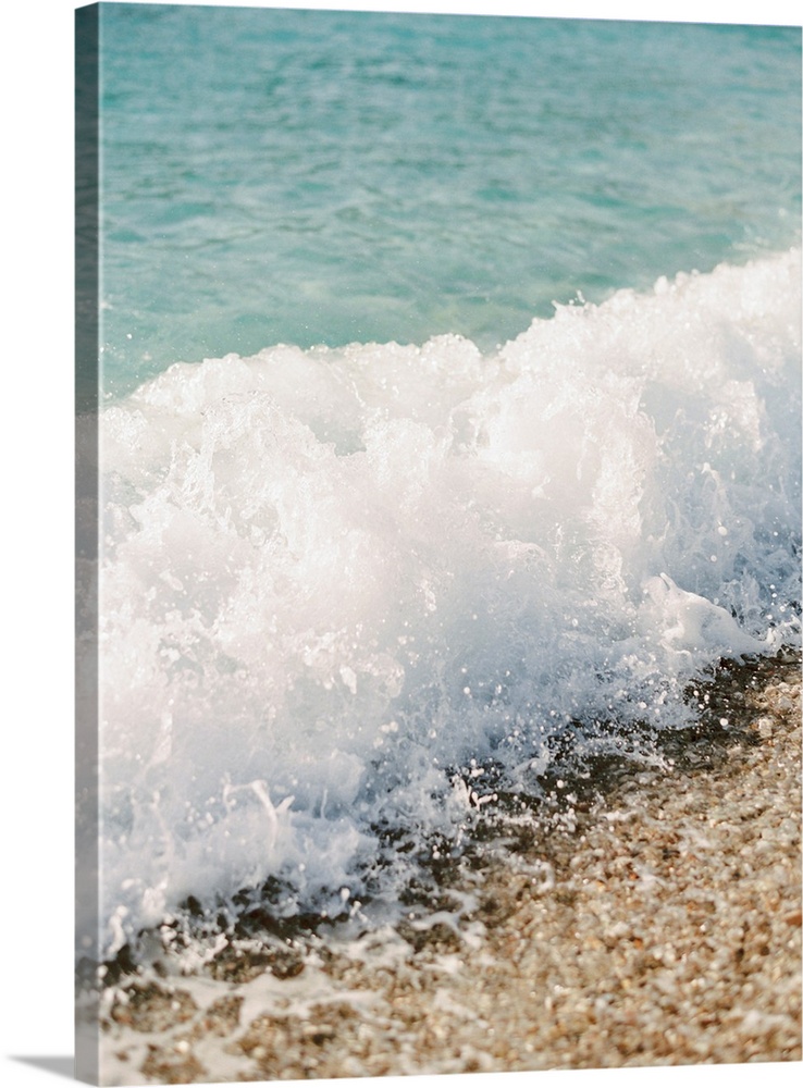 Photograph of a small wave breaking on a sandy beach, Corfu, Greece.