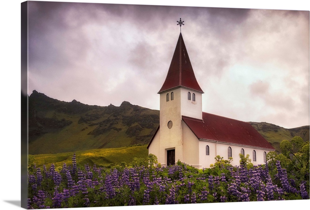 In this photo, a storm begins to brew above a peaceful church near a field of lavender.