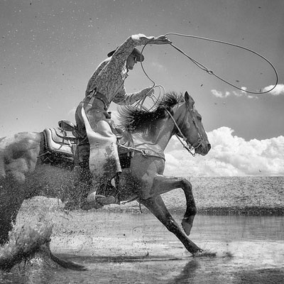 black and white photograph of a cowboy on a horse